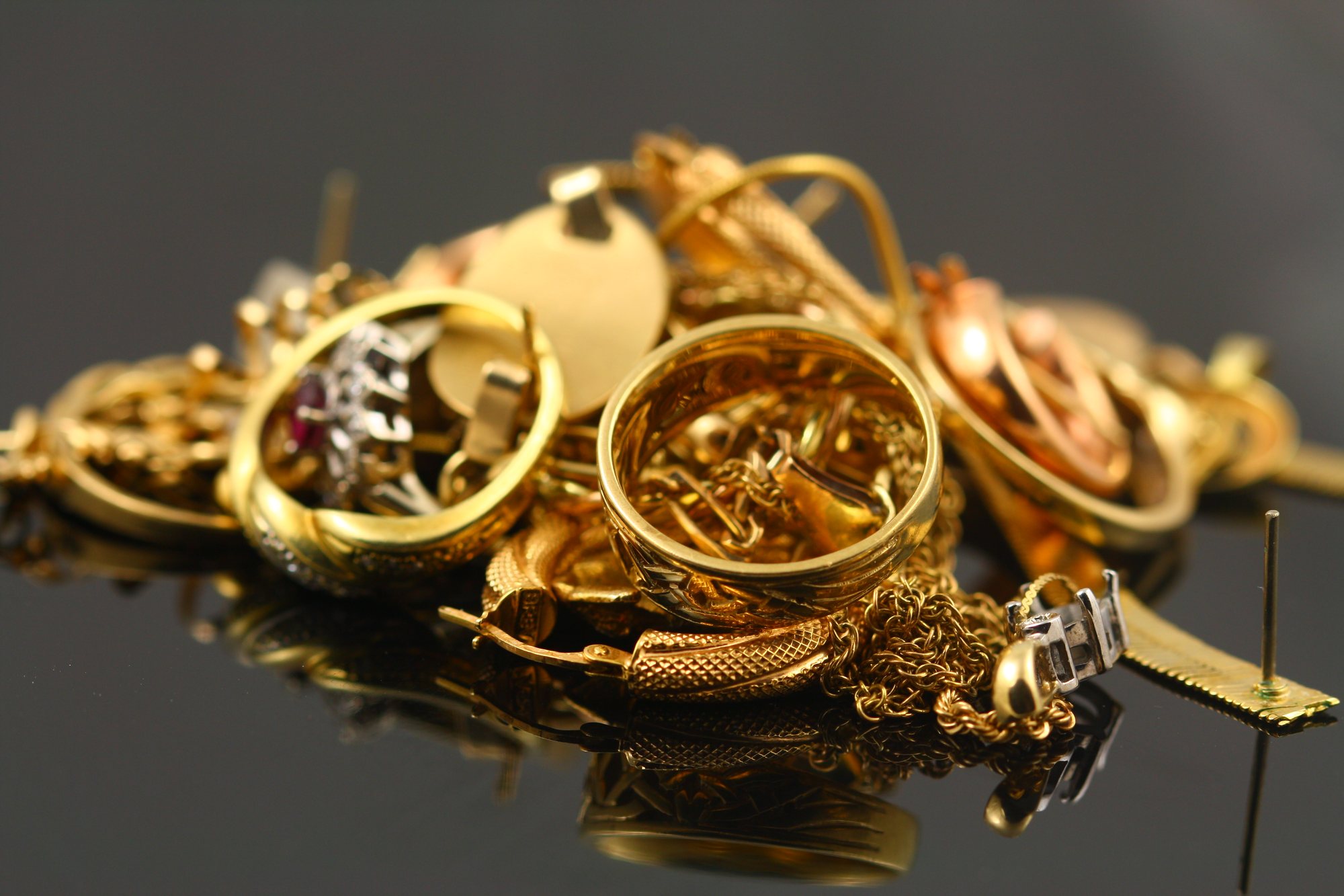 A heap of old gold jewellery: chains, rings and earrings