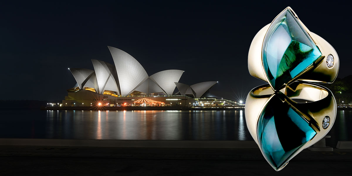 The Opera House Ring photographed against the Sydney Opera House at night, its tourmaline sail echoing the building