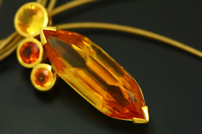 Marquise pendant: a large marquise Citrine and three round Citrines set in 18 karat yellow gold
