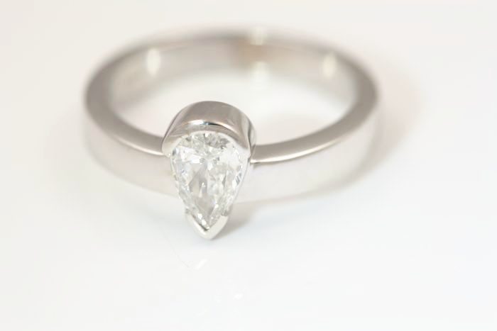 Pear diamond solitaire: a diamond set in 18 karat white gold