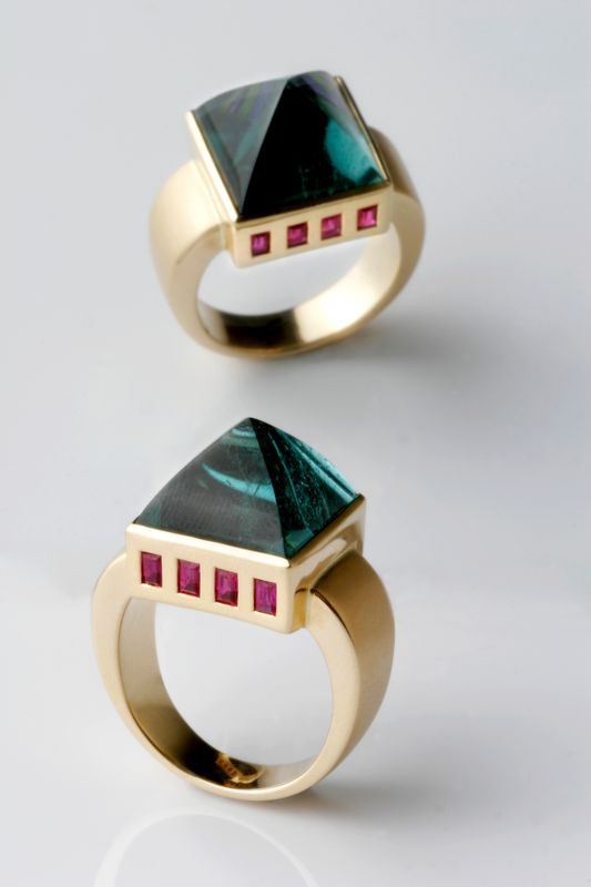 Two yellow gold rings, each with a pyramid-cut green tourmaline and a row of tiny rubies