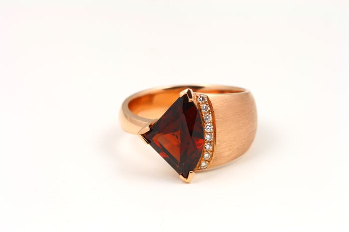 Garnet trillion ring: a Garnet with diamonds in 18 karat rose gold