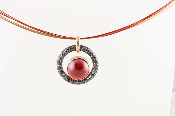 Garnet halo pendant: a Garnet with black diamonds in 18 karat gold