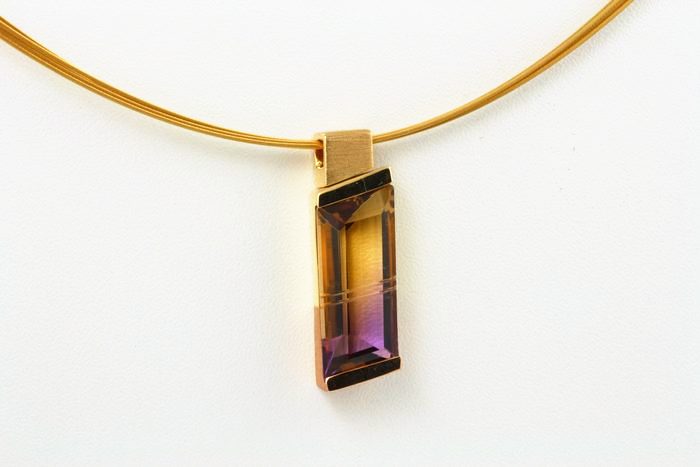 Ametrine pendant: an Ametrine set in 18 karat yellow gold