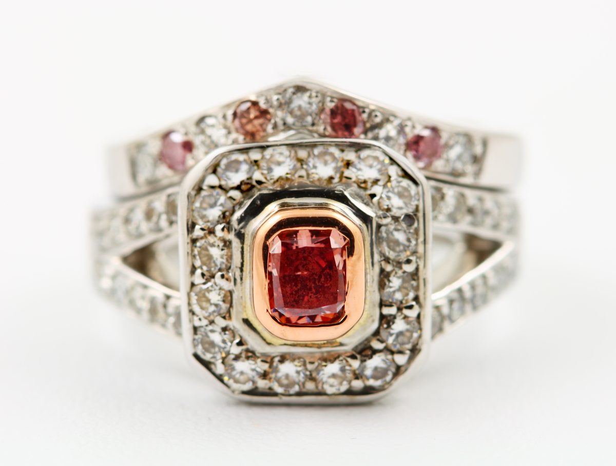 Pink diamond halo ring: a natural pink diamond with diamonds in 18 karat white gold