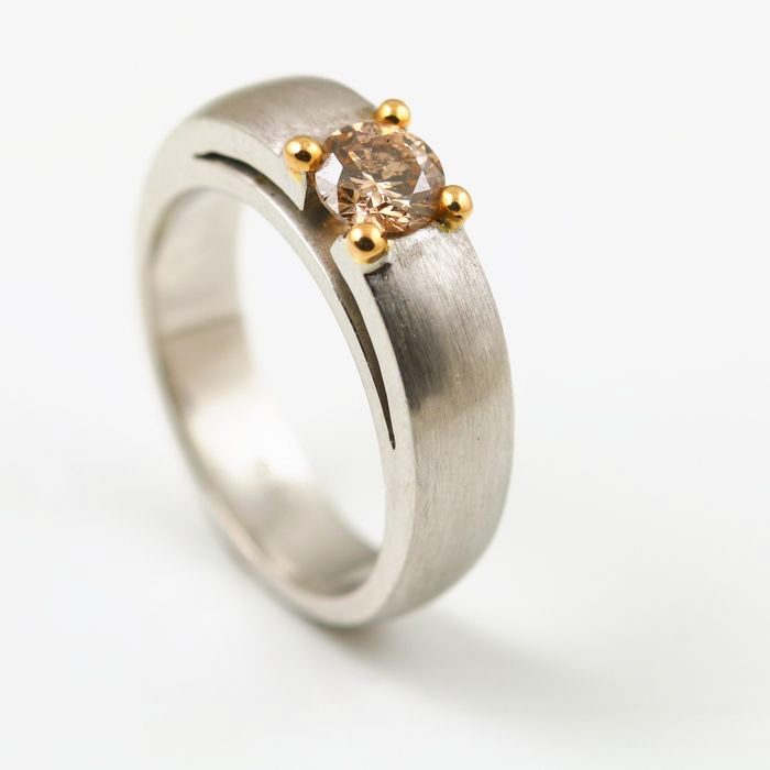 Brownish pink diamond solitaire: a brownish pink diamond in an 18 karat rose gold setting on a matte finished platinum band
