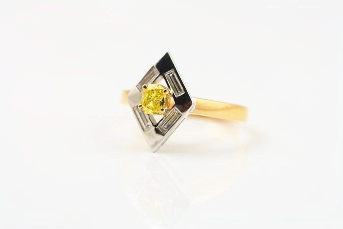 Yellow diamond kite ring: a vivid yellow diamond set in 18 karat yellow gold