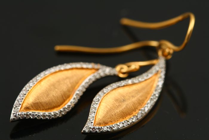 Diamond leaf earrings: diamonds set in 18 karat yellow gold