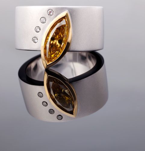 Cognac diamond marquise band: a cognac diamond with diamonds in 18 karat white and rose gold, the band matte finished