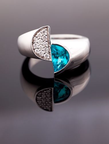 Paraiba Tourmaline half-moon ring: a Paraiba Tourmaline with diamonds in 18 karat white gold