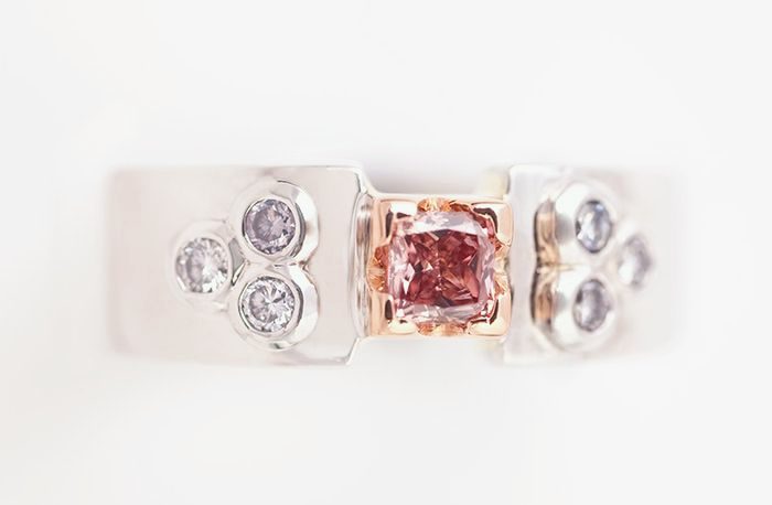 Pink diamond band ring: a pink diamond with blue diamonds in 18 karat white and rose gold