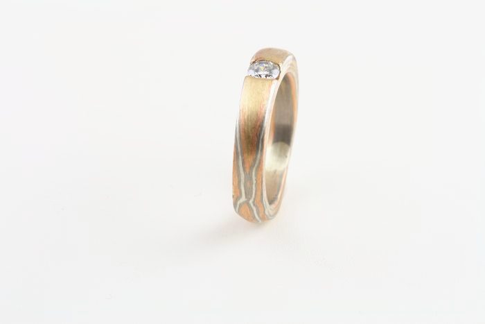 Diamond Mokume Gane ring: a diamond set in a Mokume Gane ring