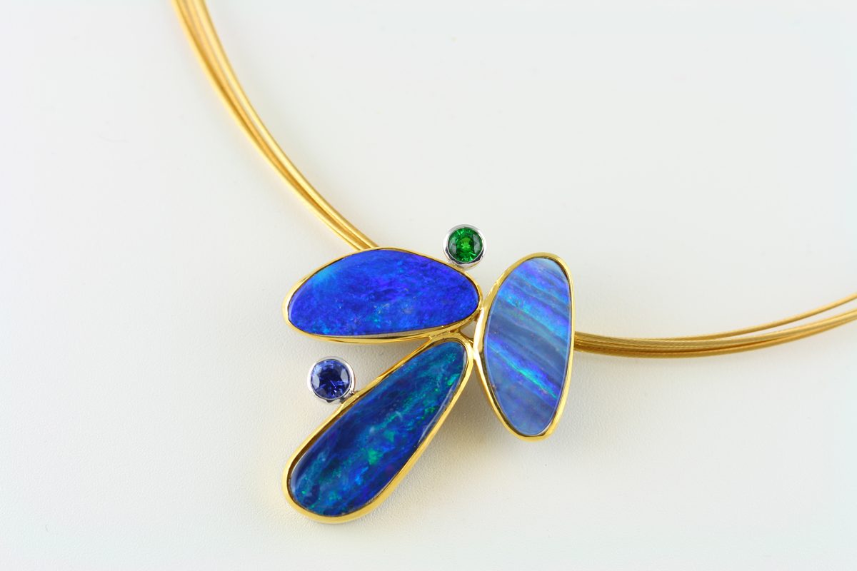 Opal butterfly: Boulder Opals with a Sapphire and a Tsavorite in 18 karat yellow and white gold