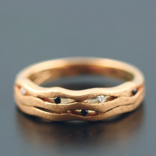 Wave band: black and colourless diamonds set in 18 karat rose gold