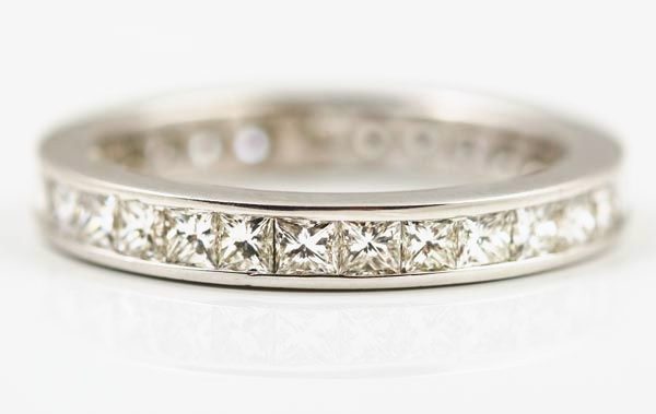 Princess cut diamond eternity ring: princess cut diamonds set in 18 karat white gold