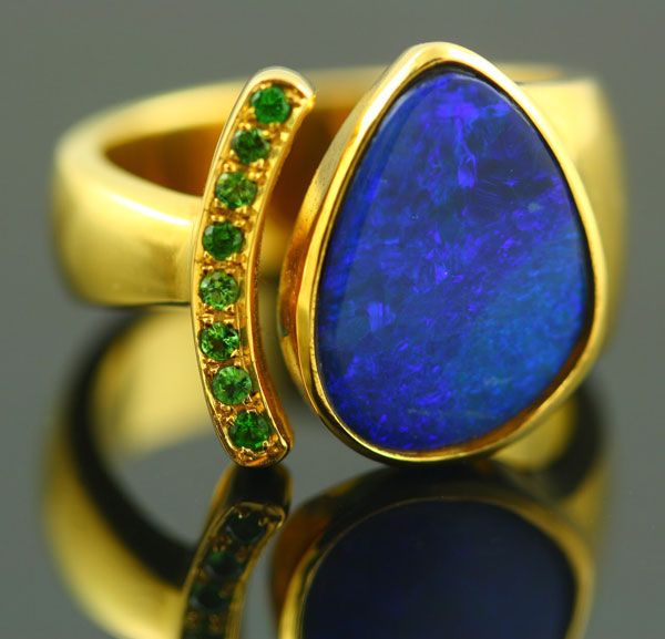 Boulder Opal ring: a Boulder Opal with Tsavorites in 18 karat yellow gold