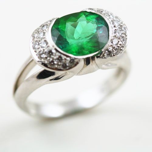 Tsavorite halo ring: a Tsavorite with diamonds in 18 karat white gold