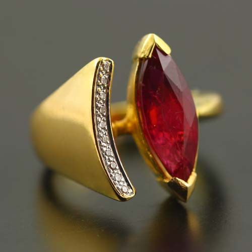 Rubellite marquise ring: a Rubellite Tourmaline with diamonds in 18 karat yellow gold