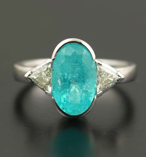 Paraiba Tourmaline and diamond ring: a Paraiba Tourmaline with trillion diamonds in 18 karat white gold