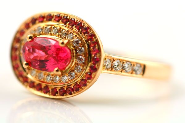 Spinel halo ring: a pink Spinel with a halo of Spinels and diamonds in 18 karat rose gold