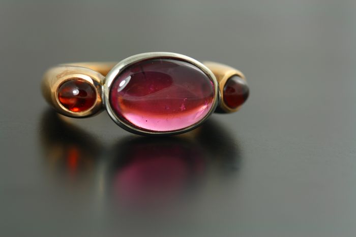 Tourmaline and Garnet cabochon ring: Rubellite Tourmaline set in 18 karat white gold with two cabochon Garnets set in 18 karat rose gold