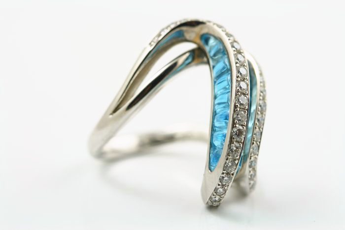 Topaz wave ring: a blue Topaz with diamonds in 18 karat white gold