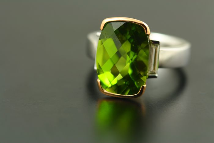 Peridot and diamond ring: Peridot set in 18 karat rose gold and two baguette diamonds set in 18 karat white gold